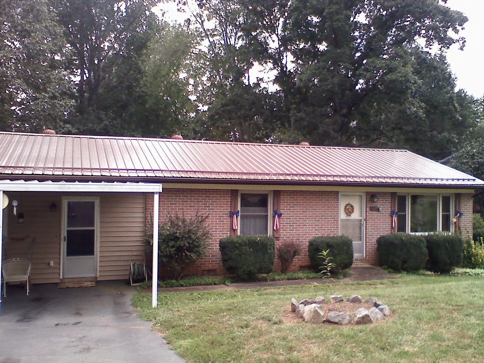 Bronze metal roof and carport on a brick ranch home — Roof Repair work by our crew in Richardsville