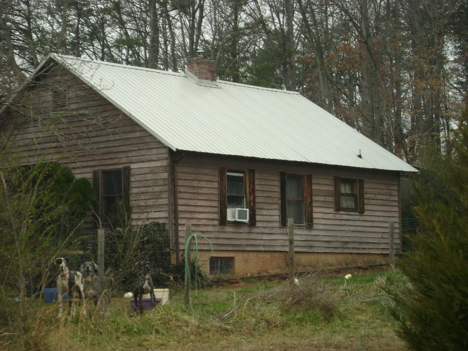 White metal roof on an old wood sided farmhouse, from a Metal Roof Installation job in Richardsville